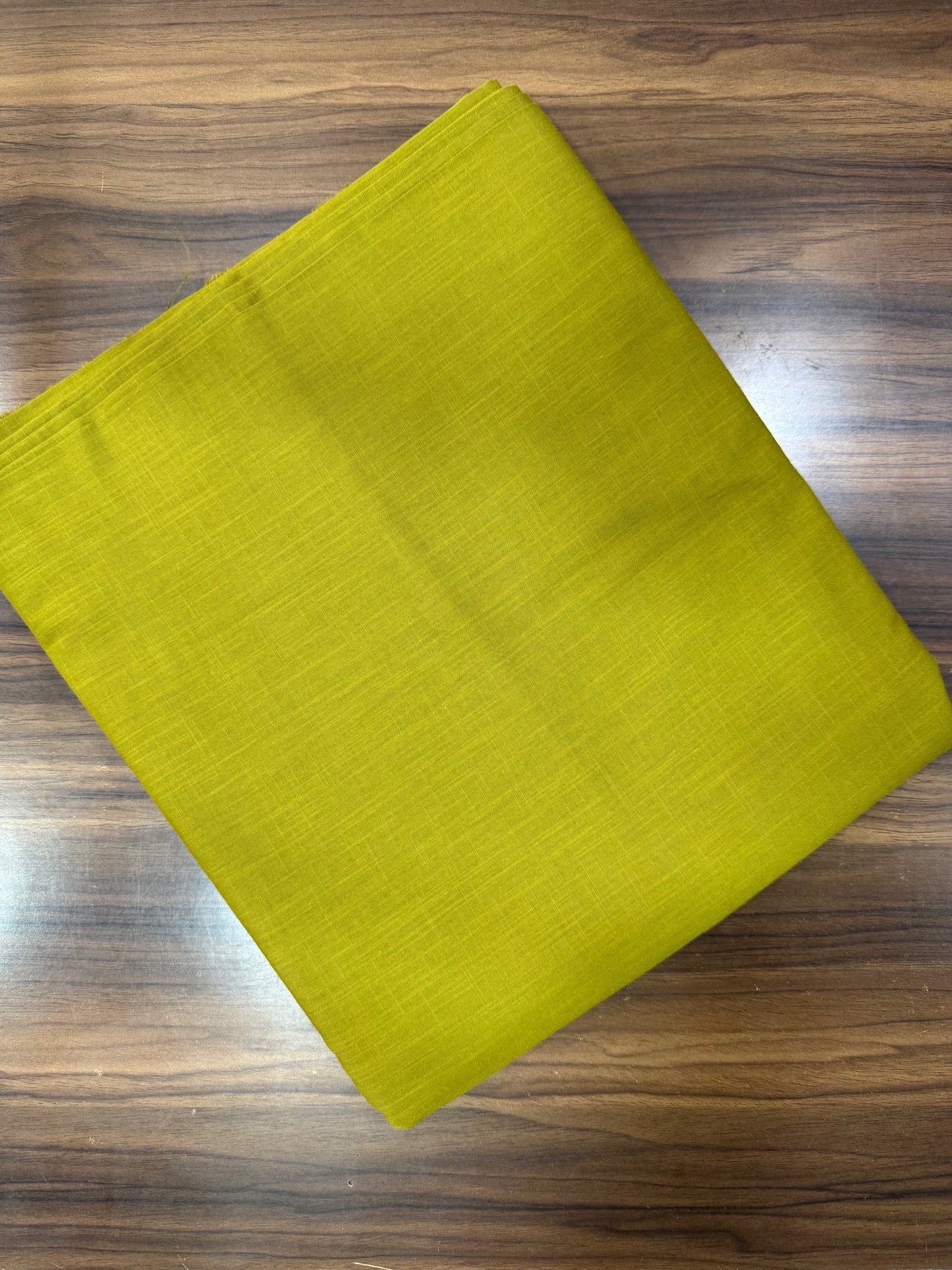 Green fabric on a wooden surface