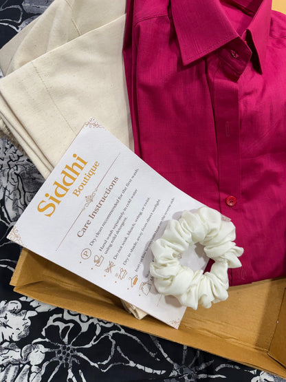 White scrunchie on a care instructions sheet with a pink shirt in the background