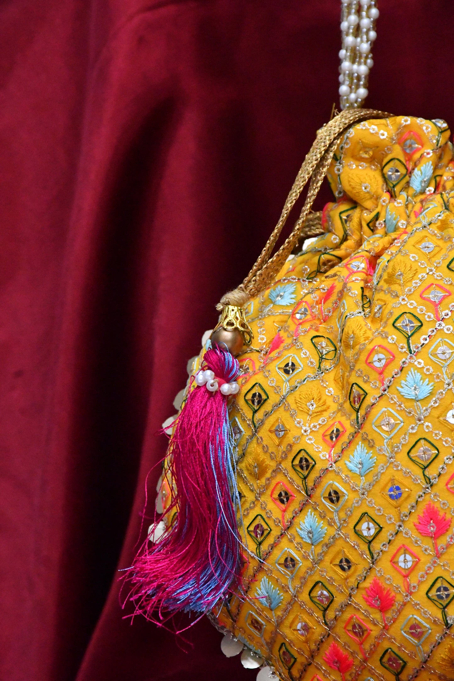 Yellow potli with multicolor embroidery
